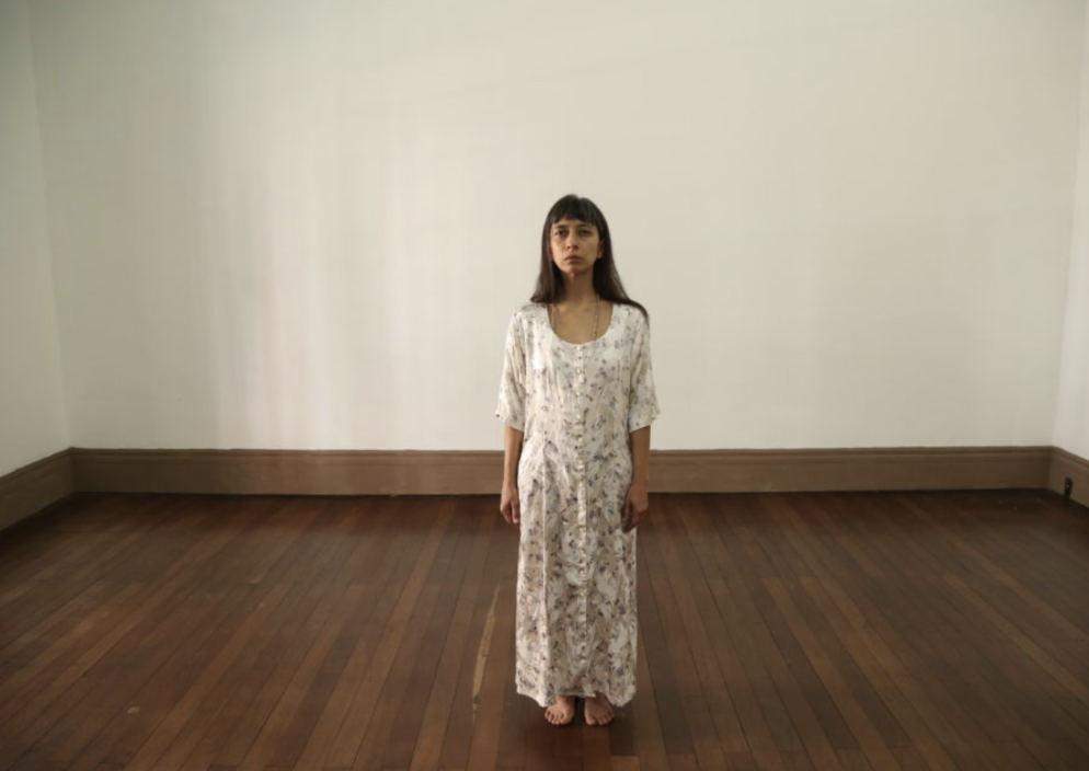 Regina José Galindo standing in empty room
